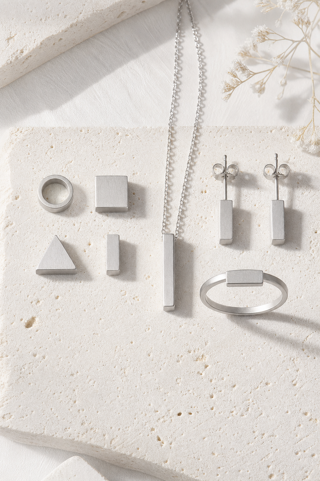 SUIJI set — bright matte titanium on pale travertine (AI placeholder)