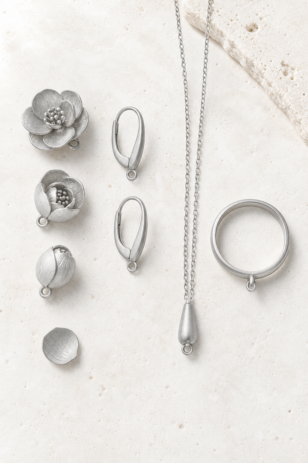 SUIJI set — bright matte titanium on pale travertine (AI placeholder)